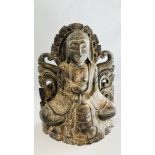A CARVED WOODEN FIGURE OF AN EASTERN DEITY.