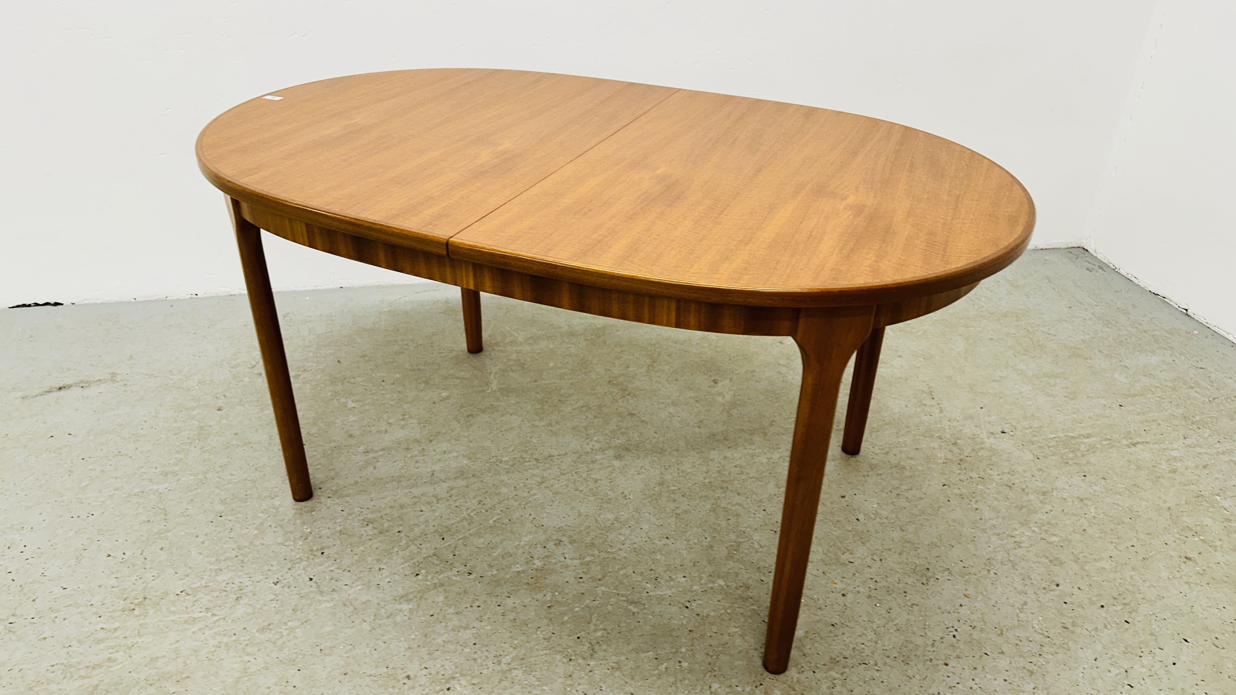 A MID CENTURY TEAK FINISH OVAL EXTENDING DINING TABLE BEARING ORIGINAL MAKERS LABEL "A.H. - Image 3 of 13