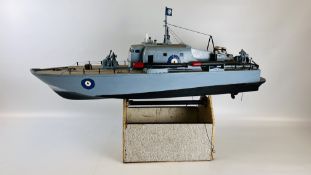 A RC MODEL OF A BATTLE SHIP ON STAND.