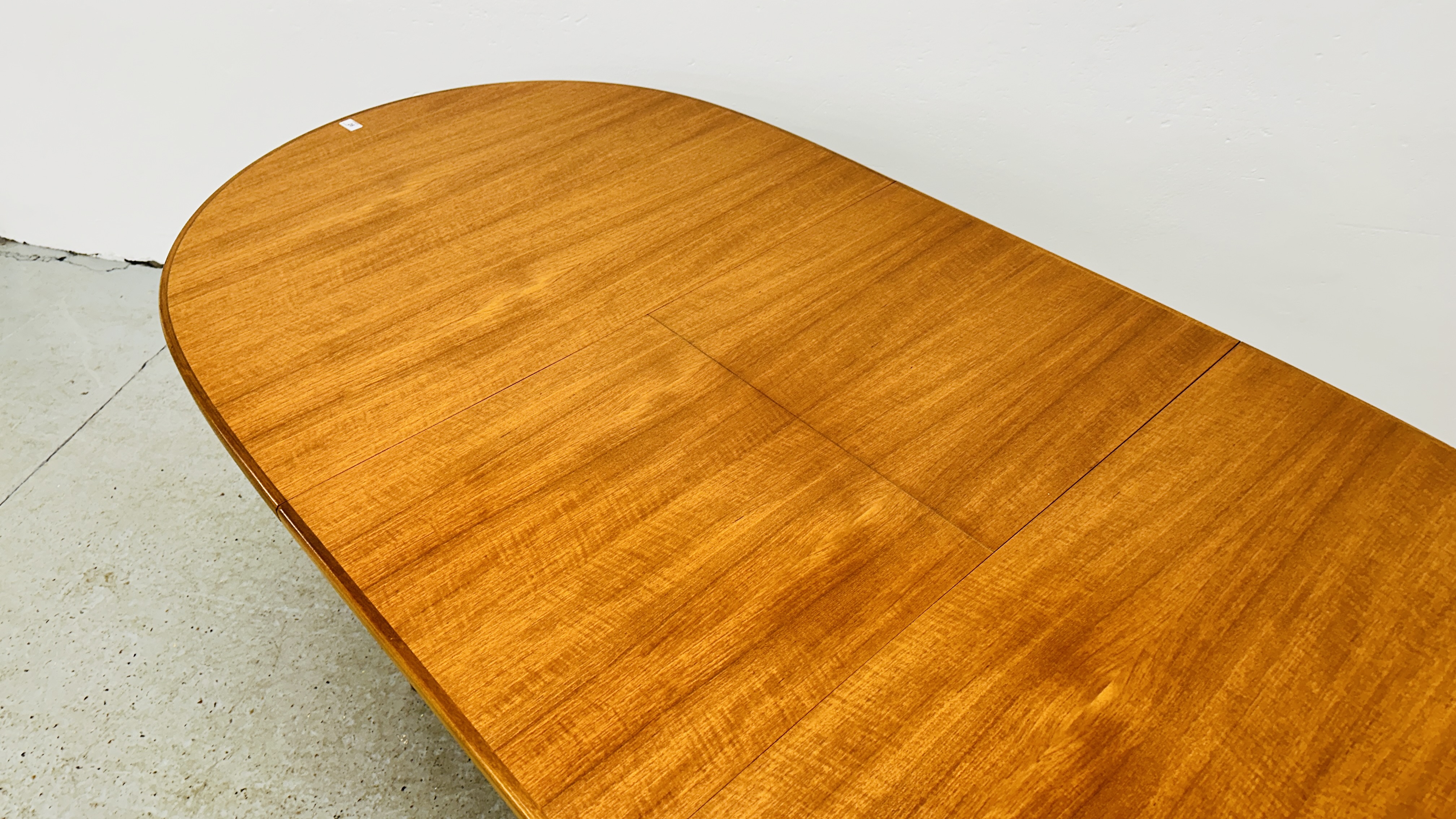 A MID CENTURY TEAK FINISH OVAL EXTENDING DINING TABLE BEARING ORIGINAL MAKERS LABEL "A.H. - Image 11 of 13