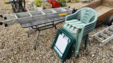 A METAL GARDEN TABLE, SIX GREEN UPVC STACKING GARDEN CHAIRS,