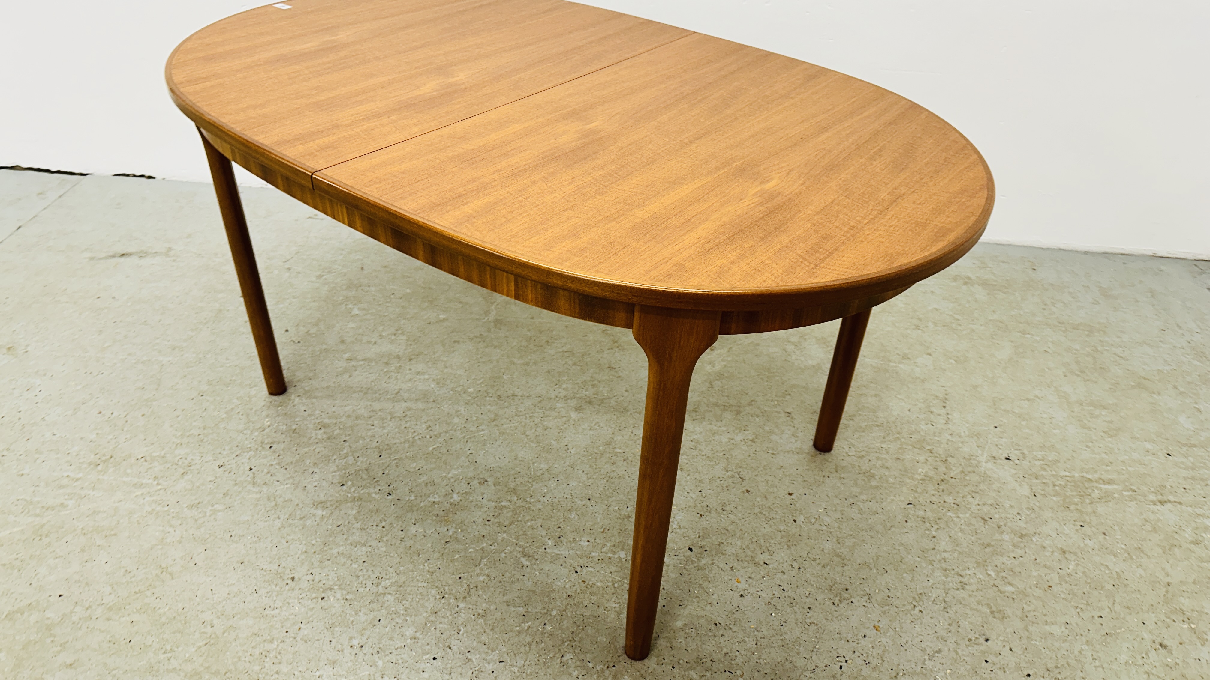 A MID CENTURY TEAK FINISH OVAL EXTENDING DINING TABLE BEARING ORIGINAL MAKERS LABEL "A.H. - Image 4 of 13