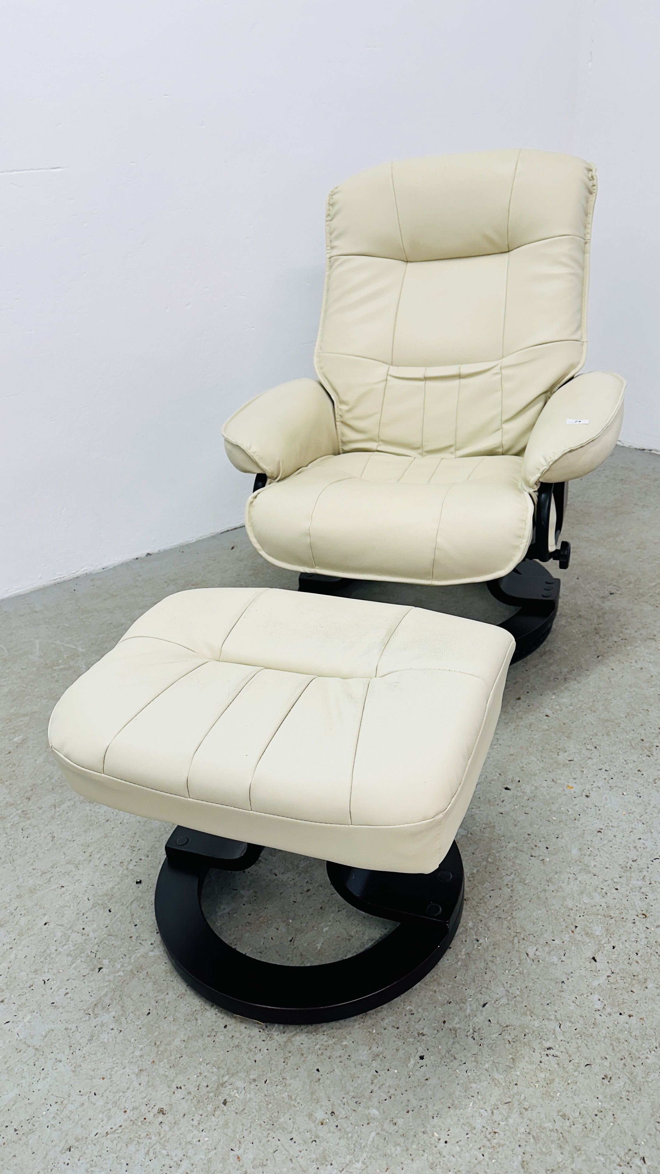 A MODERN CREAM FAUX LEATHER RECLINING RELAXER CHAIR AND FOOTSTOOL.