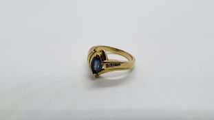 A 14K GOLD RING SET WITH 3 DIAMONDS AND A CENTRAL PALE BLUE STONE.