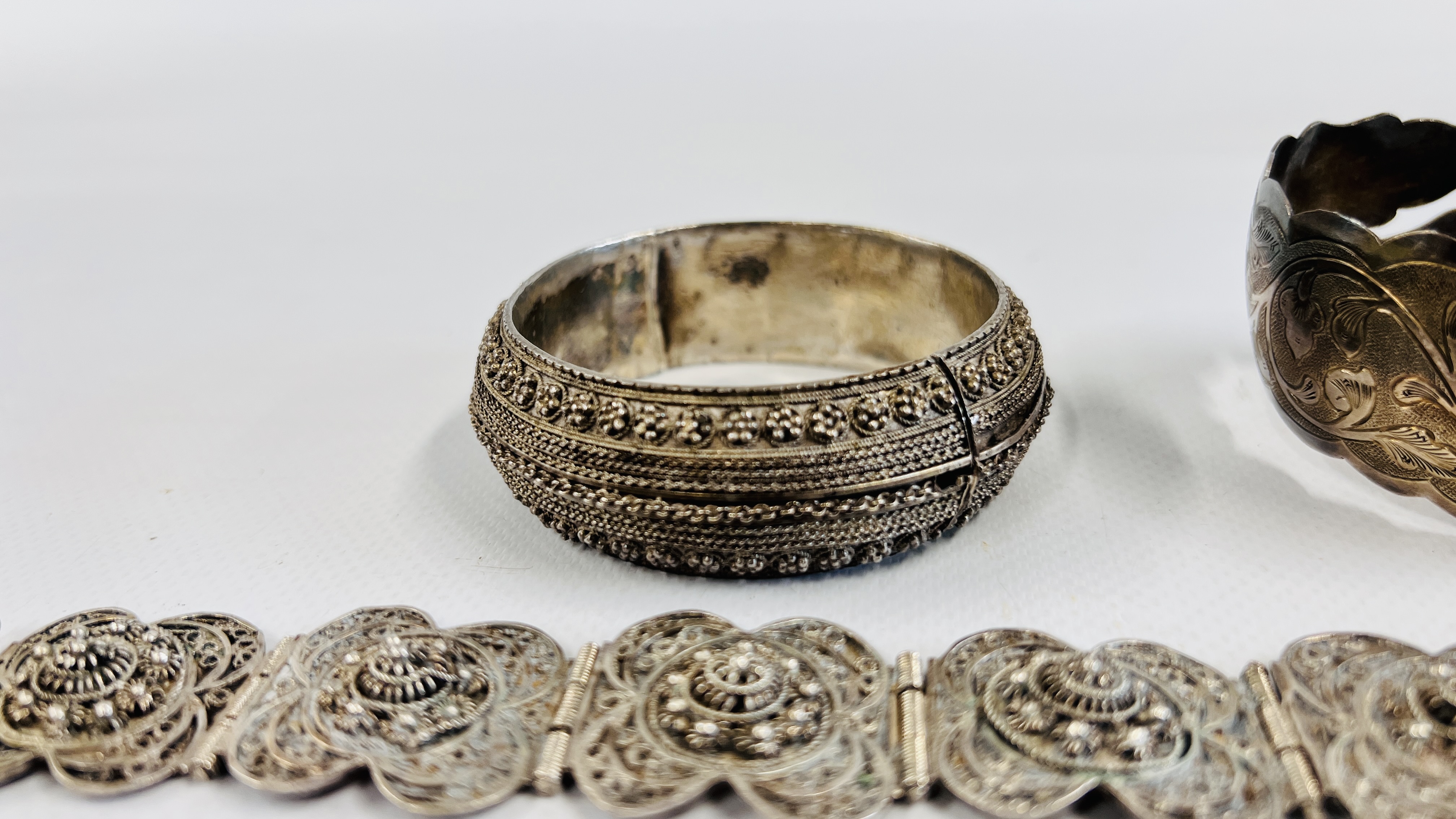 A GROUP OF FOUR SILVER EASTERN BRACELETS TO INCLUDE AN ENGRAVED CUFF, - Image 4 of 9