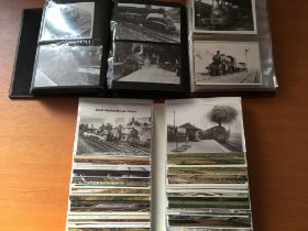 EPHEMERA: THREE BINDERS WITH PHOTOS AND POSTCARDS OF TRAINS, ROLLING STOCK, ETC (APPROX 350).