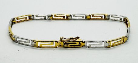 A WHITE AND YELLOW GOLD BRACELET MARKED 585 OF GREEK KEY DESIGN.