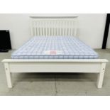 A MODERN DOUBLE WHITE FINISH BED FRAME AND A LAYEZEE BEDS POSTURE ZONE CHECKMATE MATTRESS.