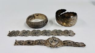 A GROUP OF FOUR SILVER EASTERN BRACELETS TO INCLUDE AN ENGRAVED CUFF,
