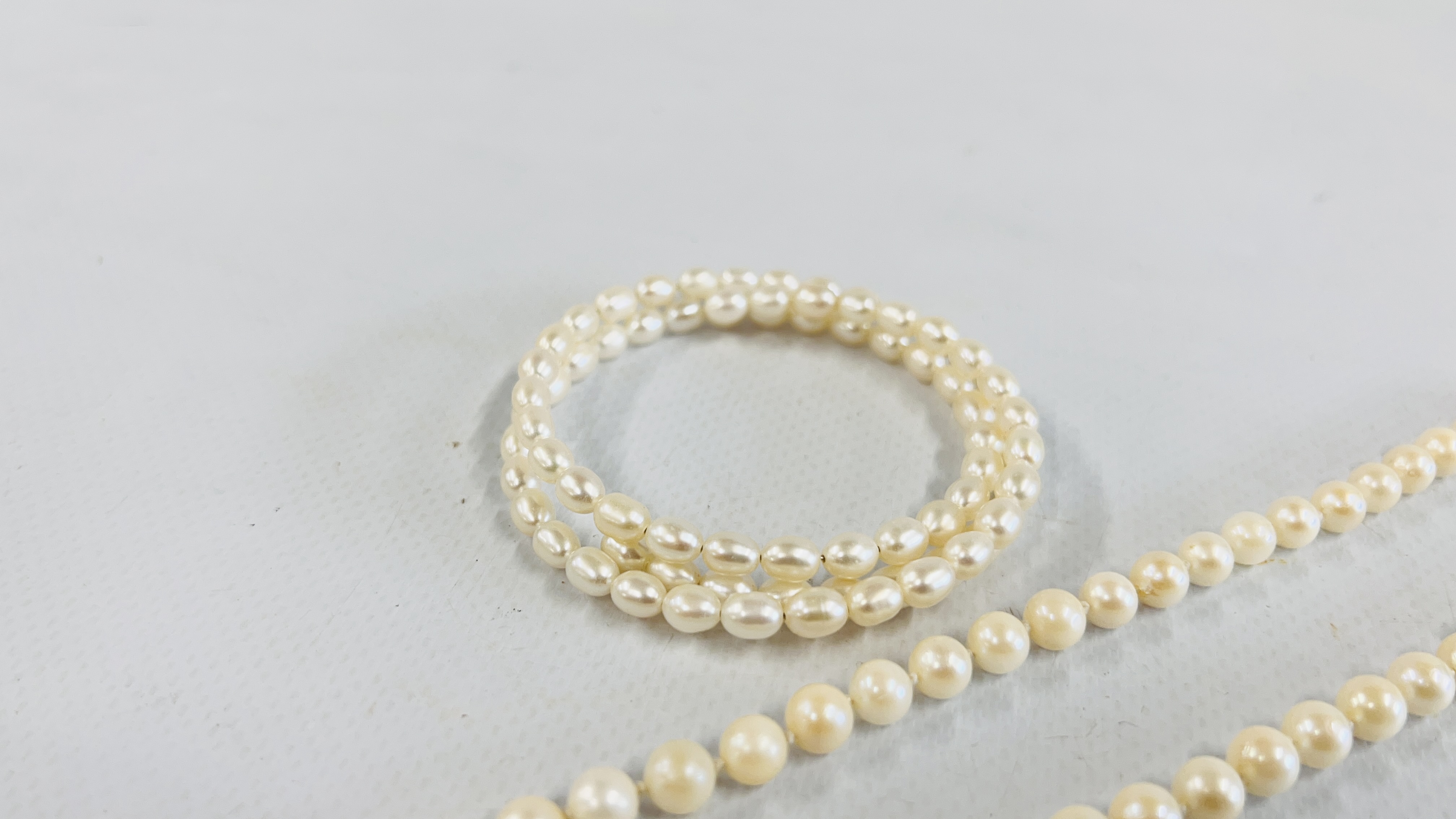 A PEARL STRAND NECKLACE WITH A 9CT GOLD CLASP AND SAFETY CHAIN AlONG WITH A PEARL BRACELET. - Image 2 of 5