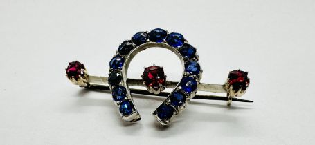 A VICTORIAN HORSESHOE STONE SET BROOCH.