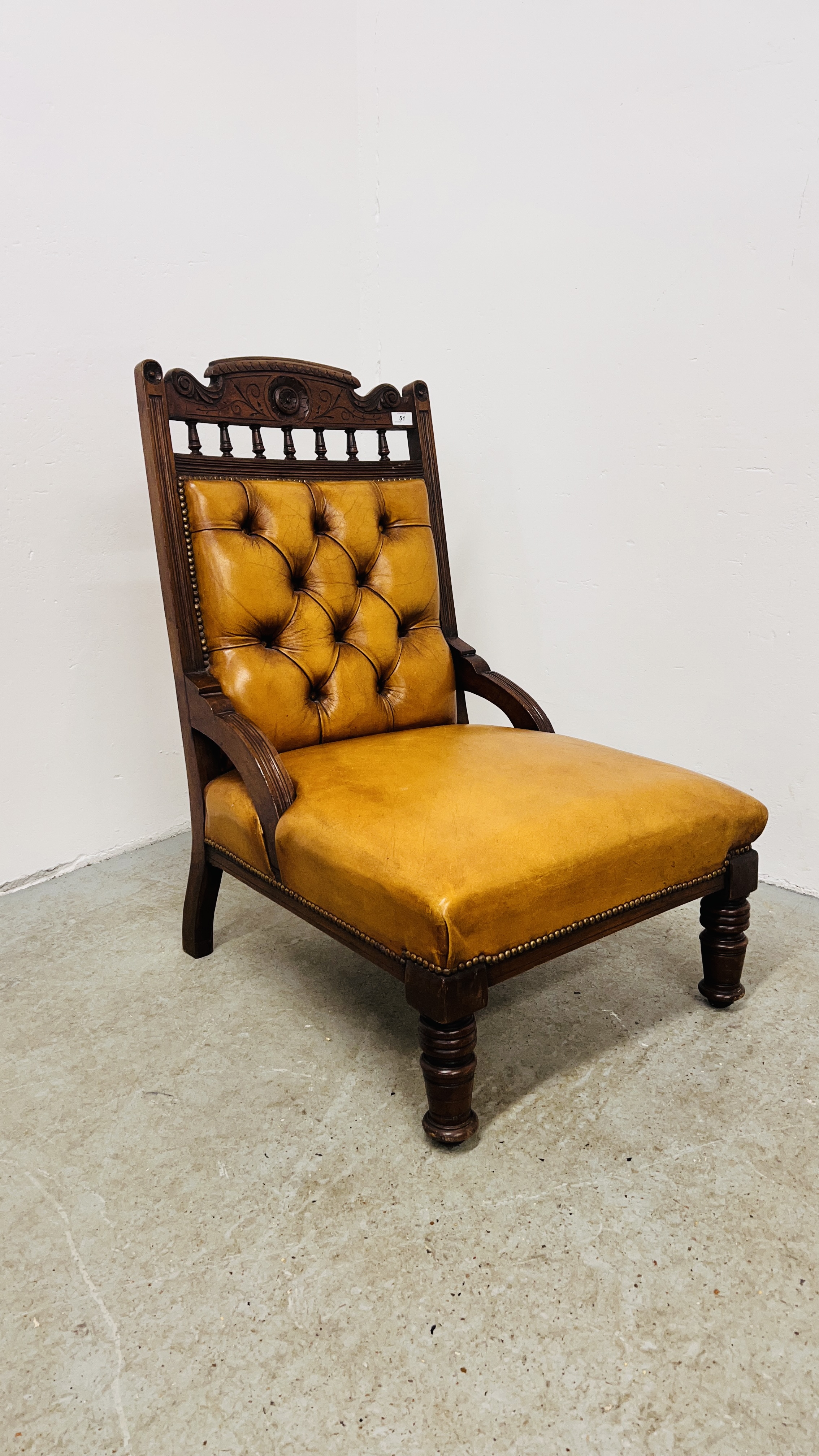 ANTIQUE EDWARDIAN MAHOGANY LOW CHAIR UPHOLSTERED IN TAN LEATHER - BUTTON BACK.