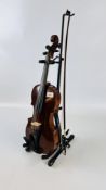 AN ANTIQUE VIOLIN COMPLETE WITH BOW, STAND AND SHOULDER PADS.