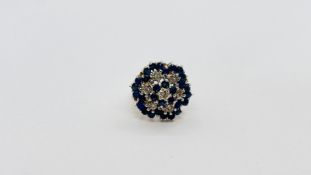 A 9CT GOLD DIAMOND AND SAPPHIRE CLUSTER RING.