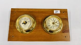 A BRASS CASED NAUTICALIA BAROMETER AND CLOCK DUO ATTACHED TO A WOODEN PLAQUE.