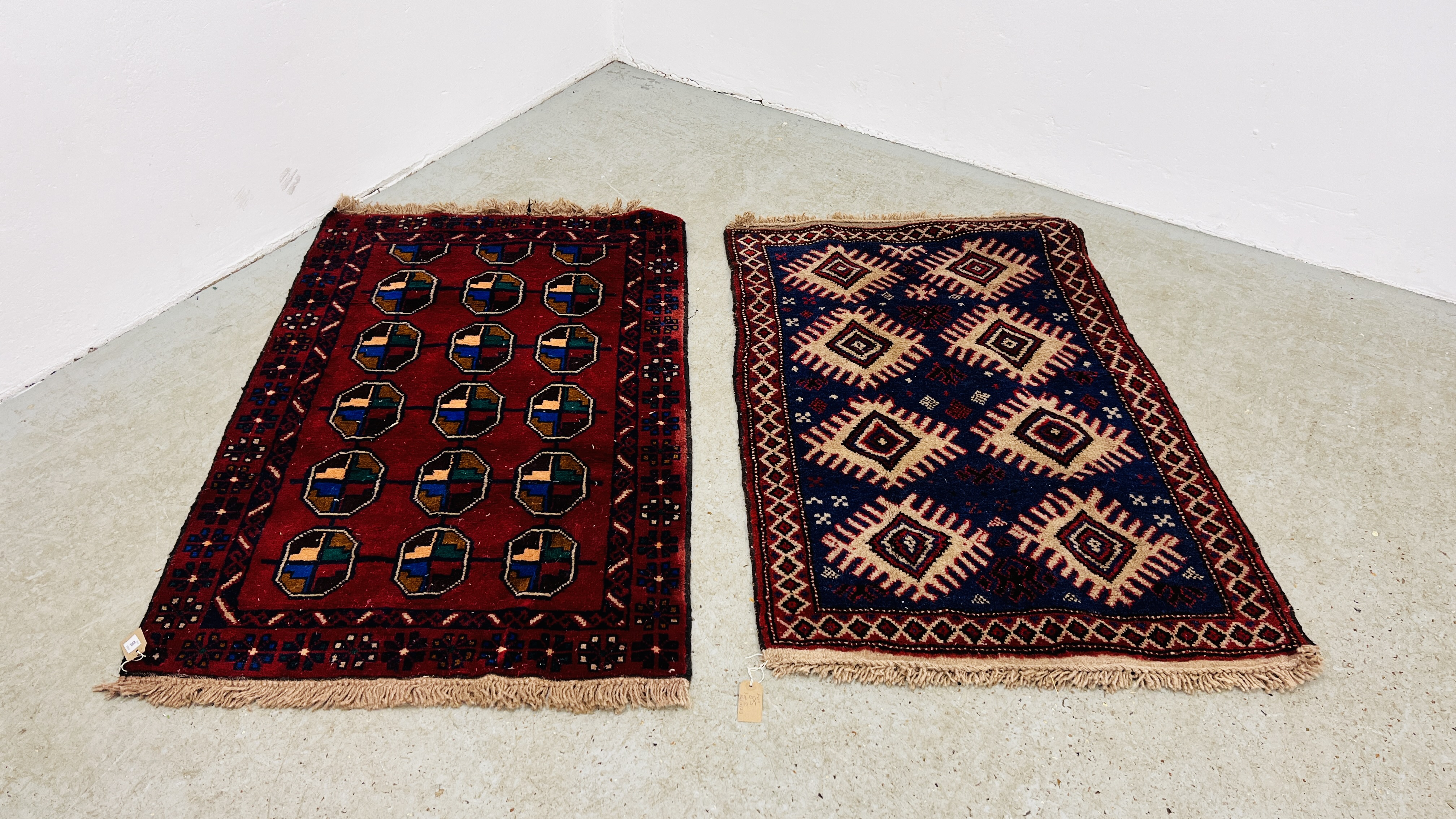 TWO RED / BLUE PATTERNED EASTERN RUGS EACH 133CM X 86CM.