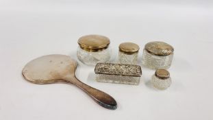 A GROUP OF 5 SILVER LIDDED DRESSING TABLE JARS ALONG WITH A SILVER BACKED HAND MIRROR.