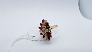 A DIAMOND AND RUBY CLUSTER RING MARKED 14K 585.