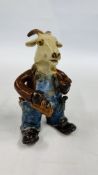 A MODERN STUDIO POTTERY FIGURE OF A CARPENTER GOAT WEARING BLUE DUNGAREES SMOKING A PIPE, H 16CM.