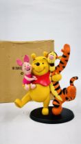 A DISNEY WINNIE THE POOH FIGURE.