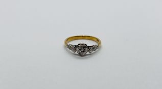 AN 18CT GOLD AND PLATINUM HEART RING.