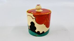 A CLARICE CLIFF FANTASQUE BIZARRE CIRCULAR JAM POT, THE COVER DECORATED PREDOMINANTLY IN RED,