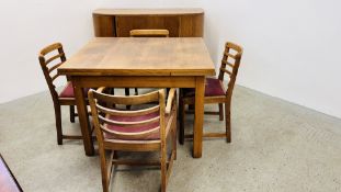 A 1930's OAK DINING SUITE COMPRISING DRAWER LEAF DINING TABLE, FOUR DINING CHAIRS AND SIDEBOARD.