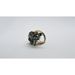 A DIAMOND AND TOPAZ CLUSTER RING MARKED 14K 585.