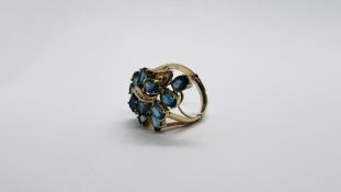 A DIAMOND AND TOPAZ CLUSTER RING MARKED 14K 585.