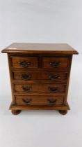 A MINIATURE 2 OVER 3 OAK CHEST OF DRAWERS, W 36CM X D 23CM X H 40CM.