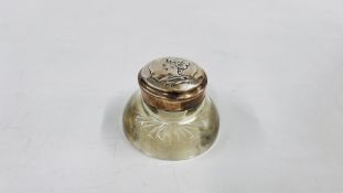 AN ANTIQUE ART NOUVEAU SILVER TOPPED GLASS INKWELL AND LINER.