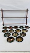 A GROUP OF 13 RUSSIAN LEGENDS COLLECTORS PLATES ALONG WITH A MAHOGANY WALL HANGING PLATE RACK.