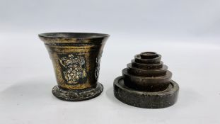 A GROUP OF 6 VINTAGE GRADUATED WEIGHTS OF LOCAL INTEREST ALONG WITH A CAST MORTAR.