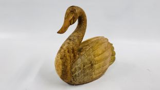 A CARVED WOODEN SWAN - HEIGHT 41CM X LENGTH 40CM.
