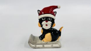 A LORNA BAILEY COLLECTORS CAT ON A SLEIGH BEARING SIGNATURE H 12.5CM.