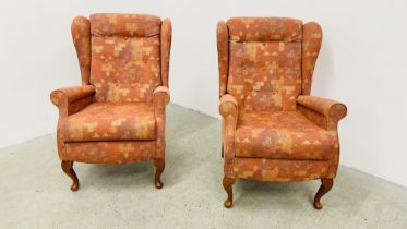 A PAIR OF SHERBORNE RED PATTERN UPHOLSTERED WINGED EASY CHAIRS.