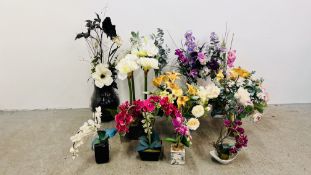A GROUP OF 11 ARTIFICIAL FLOWER ARRANGEMENTS TO INCLUDE ORCHIDS, MANY IN GLASS VASES.