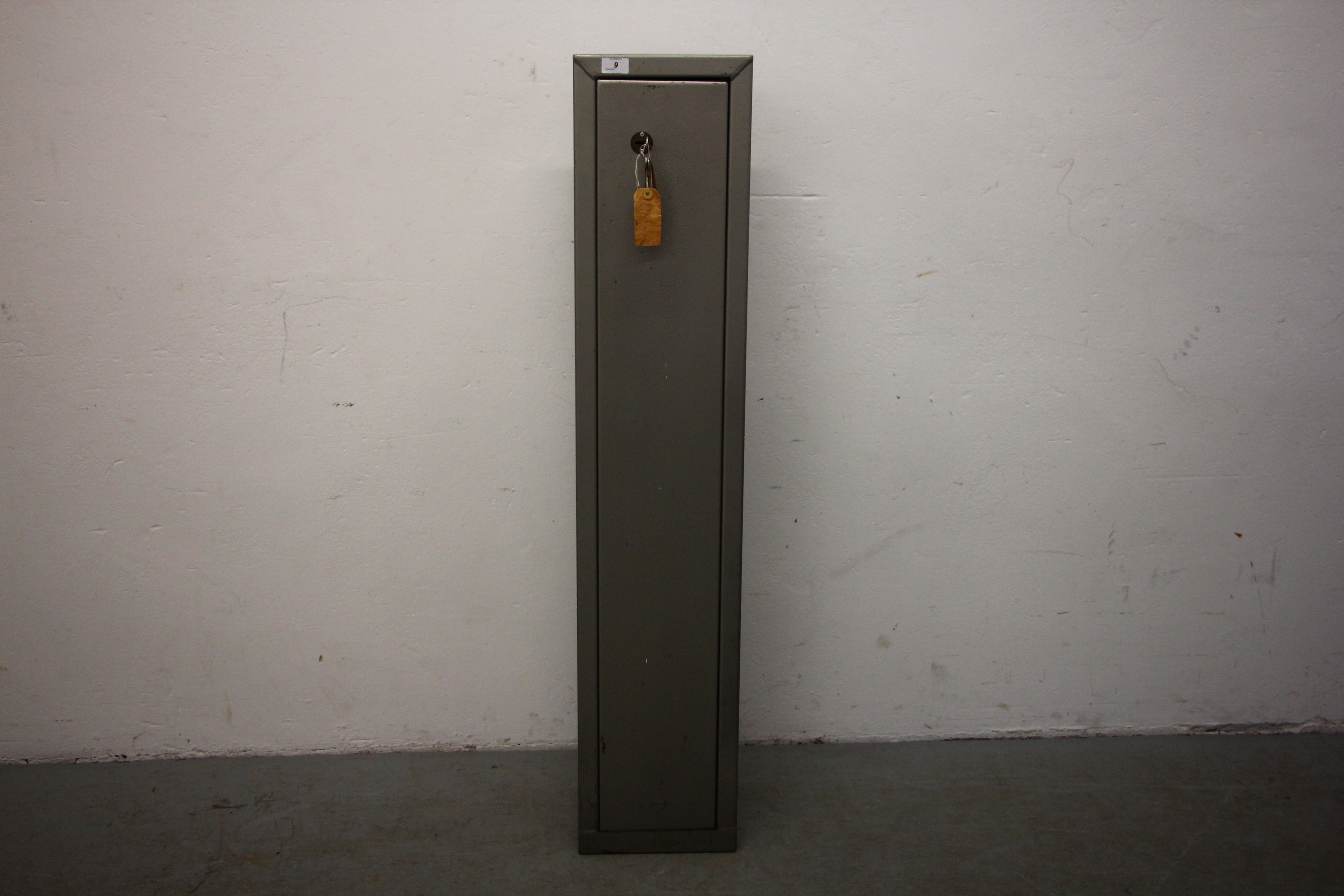 A STEEL THREE GUN CAPACITY SHOTGUN SAFE, KEYS WITH AUCTIONEER,