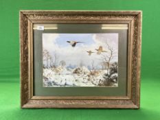 A GILT FRAMED PRINT DEPICTING PHEASANT IN FLIGHT OVER A SNOW COVERED LANDSCAPE BY HARRISON,