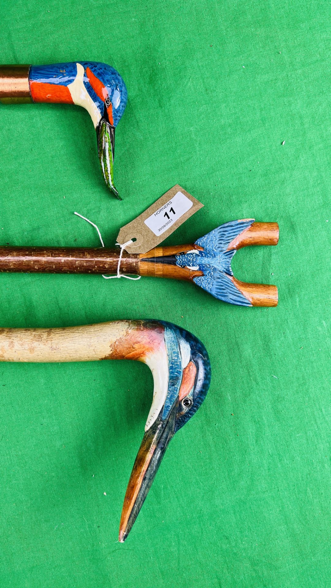 TWO WALKING STICKS WITH HANDCARVED AND PAINTED DUCK HEAD DETAIL AND A FURTHER THUMB STICK WITH