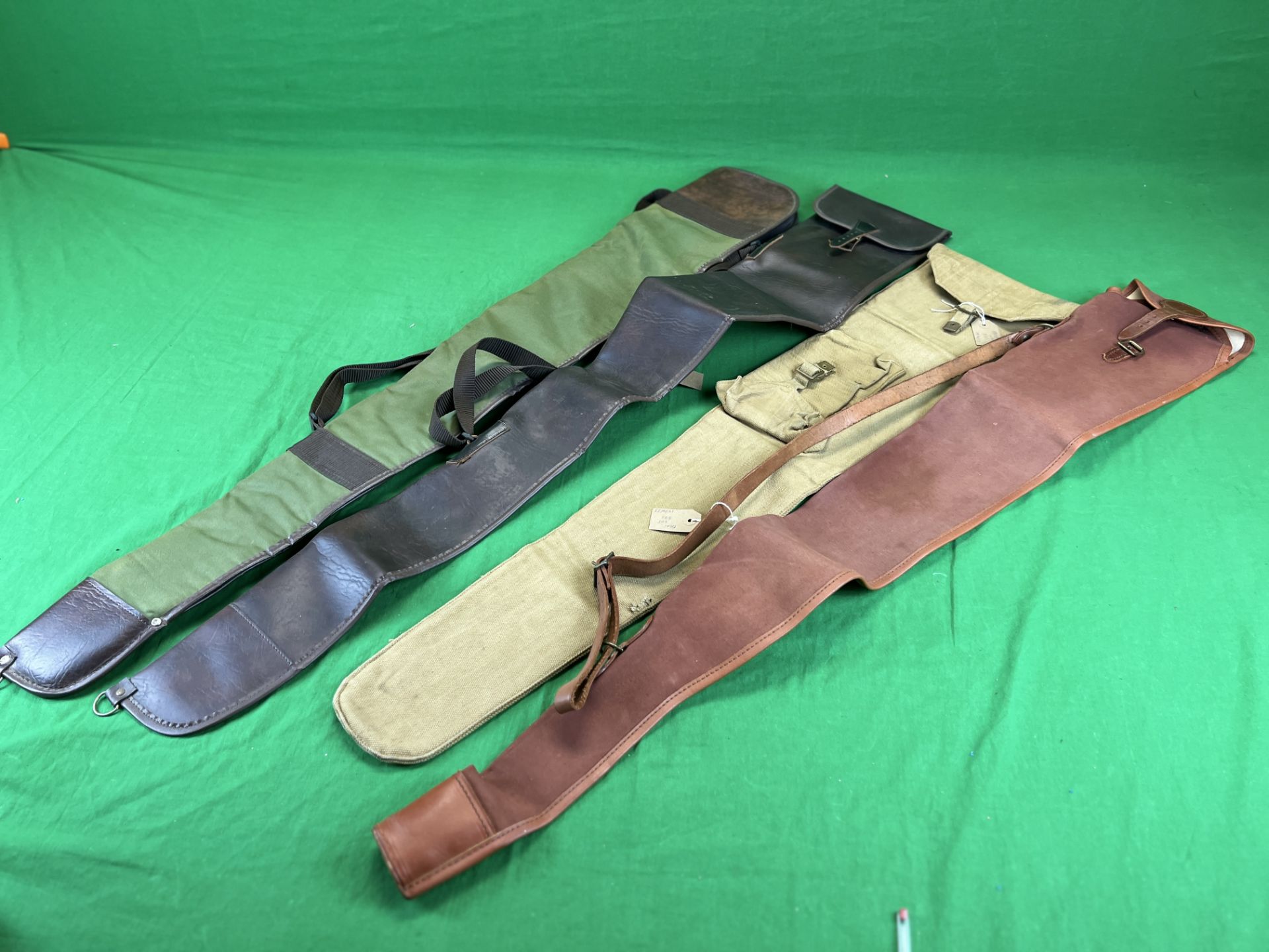 FOUR VARIOUS GUN SLIPS TO INCLUDE CANVAS AND LEATHER