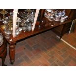 A mahogany coffee table on castors - length 135cms