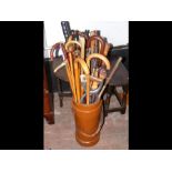 A leather umbrella/stick stand containing various