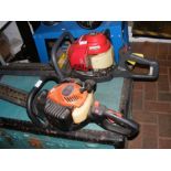 A Honda HHH25 Petrol Strimmer, together with a Tan