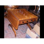 A Victorian sofa table with cross banded top and t