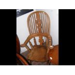 An antique country stick back armchair
