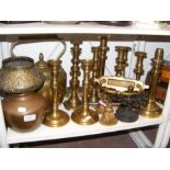 A selection of brass candlesticks and other metal