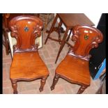 A pair of Victorian mahogany hall chairs with shap