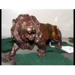 A small bronze style lion ornament - 15cms long
