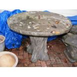 An unusual concrete faux tree trunk garden table